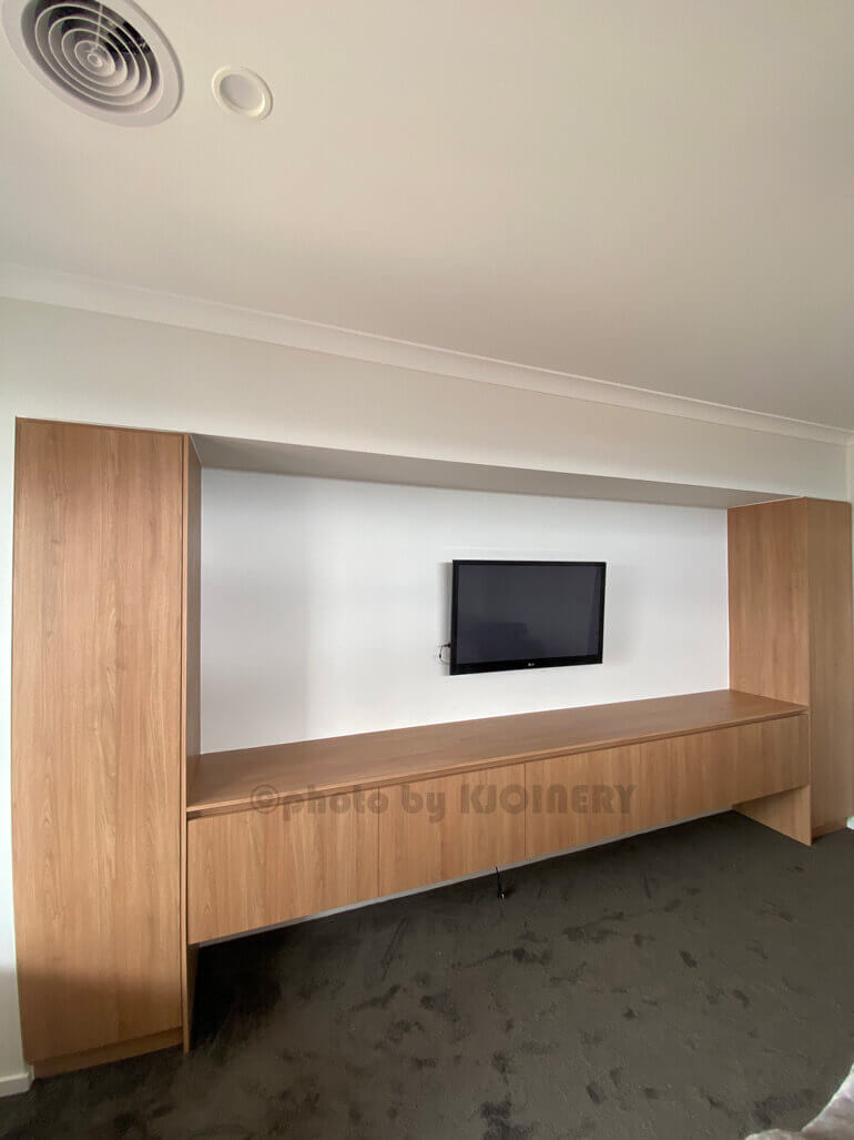 Floating TV cabinet installed under a wall-mounted TV in Melbourne