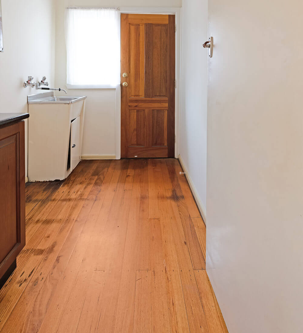 Melbourne laundry before renovation with a dated freestanding tub and no storage