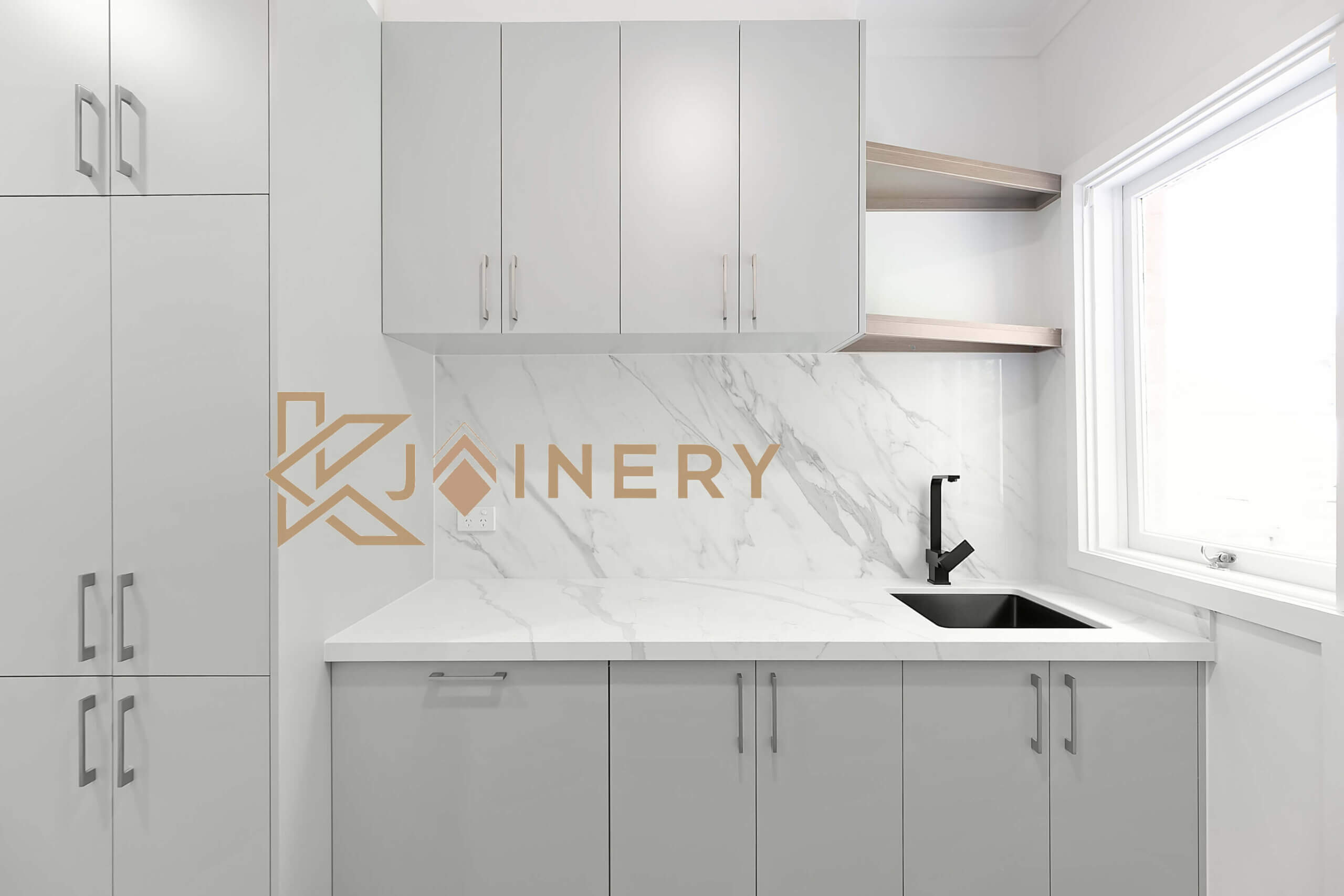 White laundry cabinets with marble splashback and open shelving in Melbourne