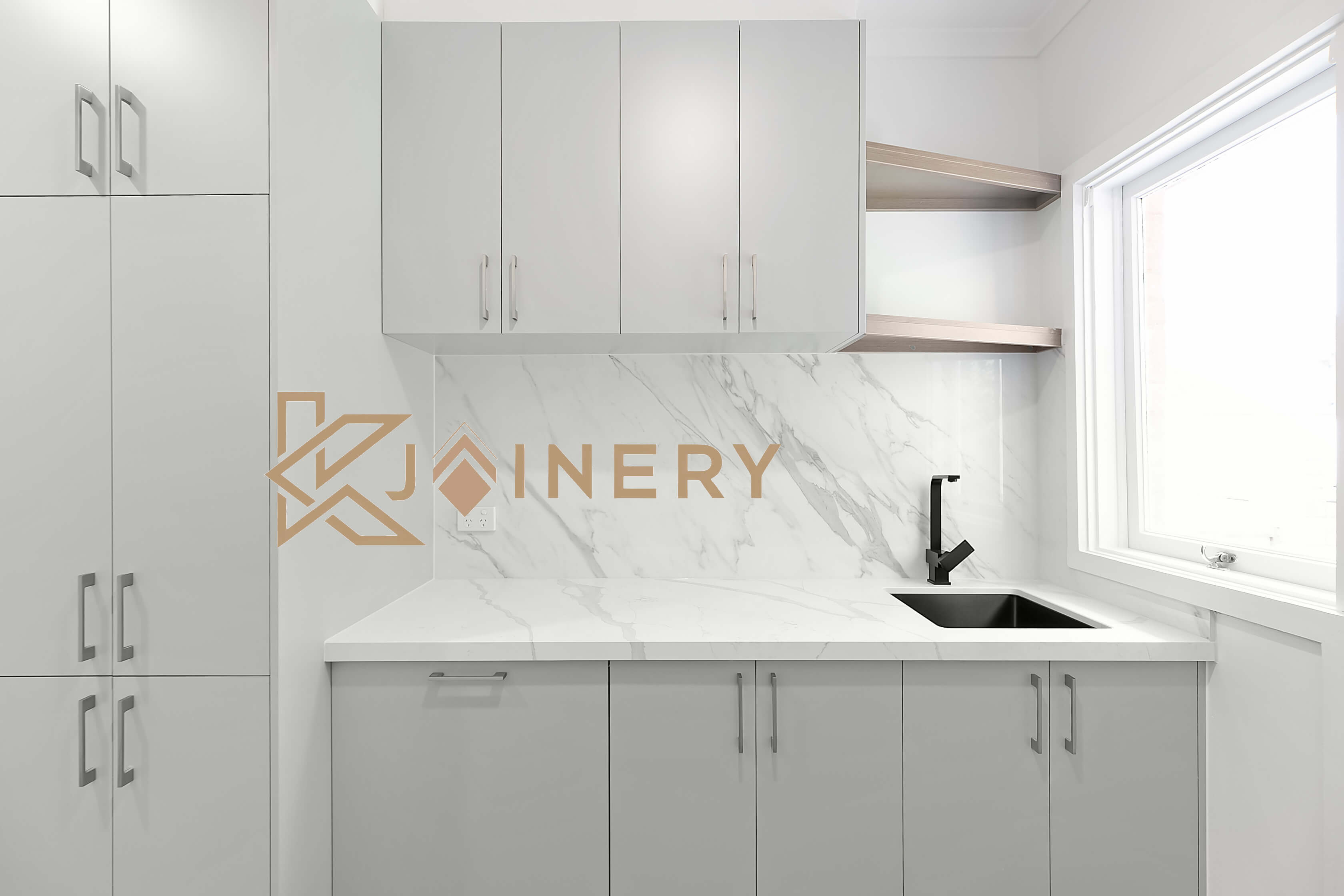 Galley laundry with white cabinetry, stone benchtop and open shelving in Melbourne by KJoinery Australia
