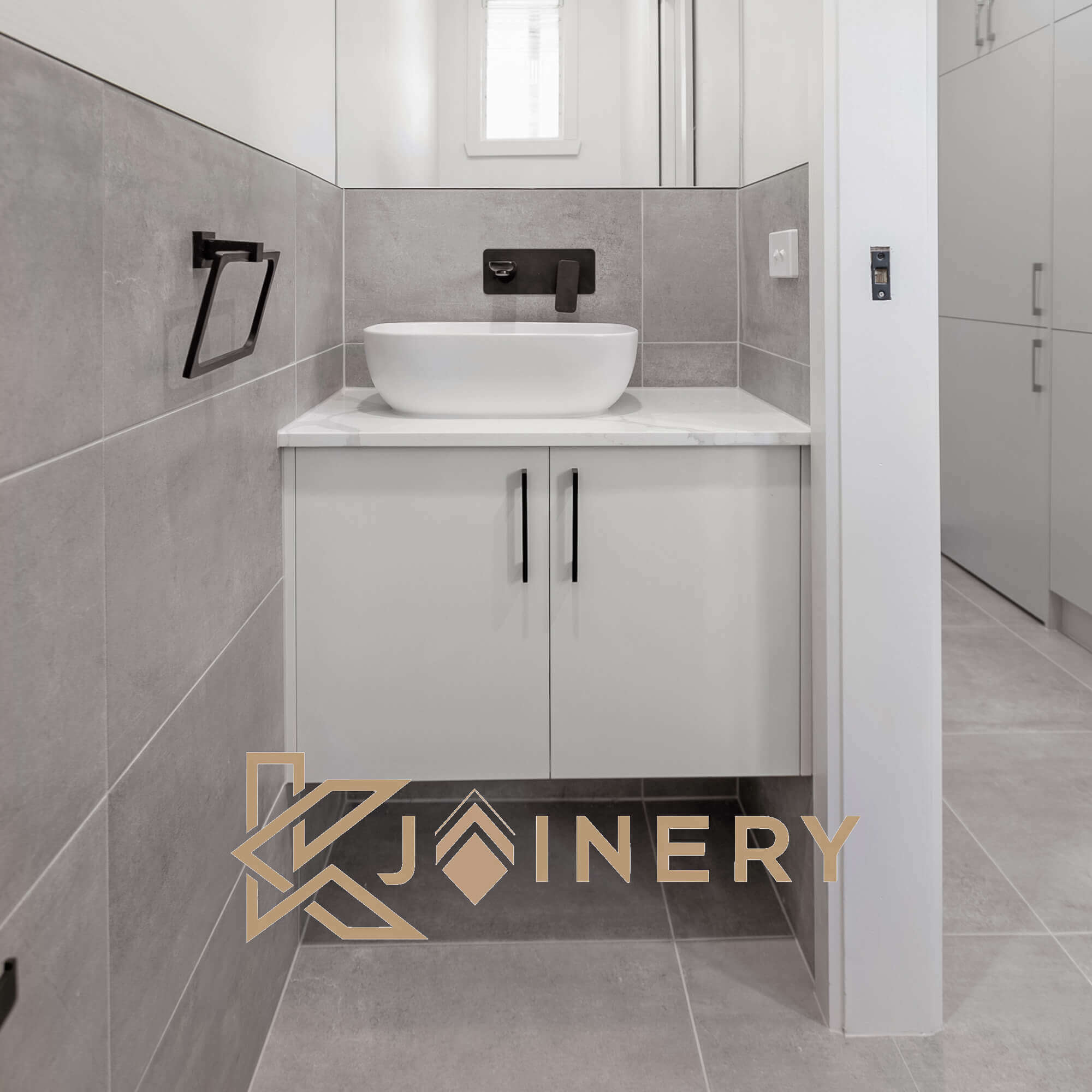 Combined laundry and powder room with custom vanity and tiling in Melbourne