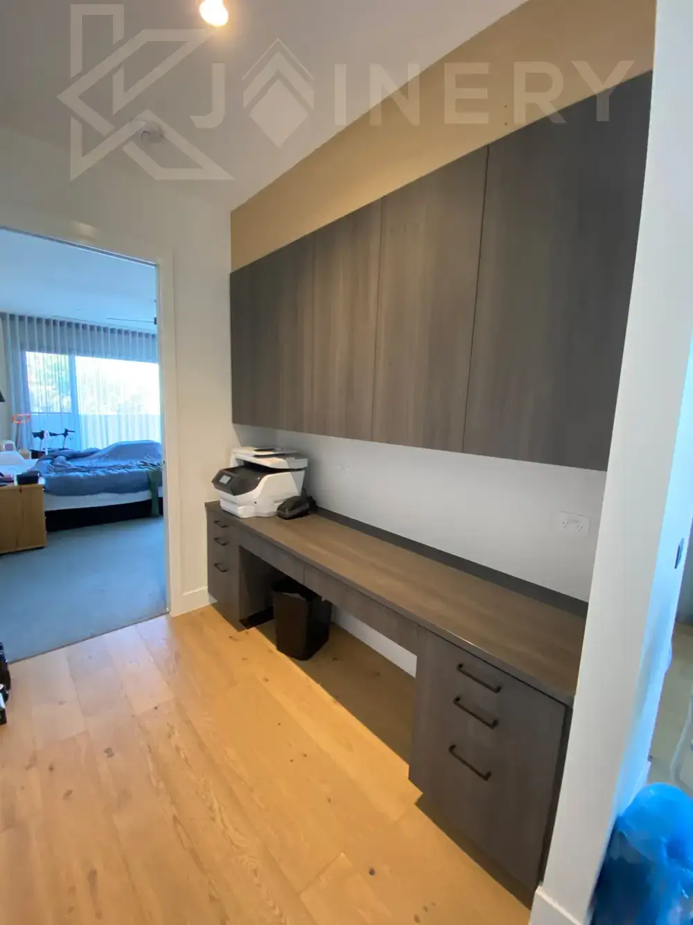 Built-in home office with a timber desk and shelving in Melbourne