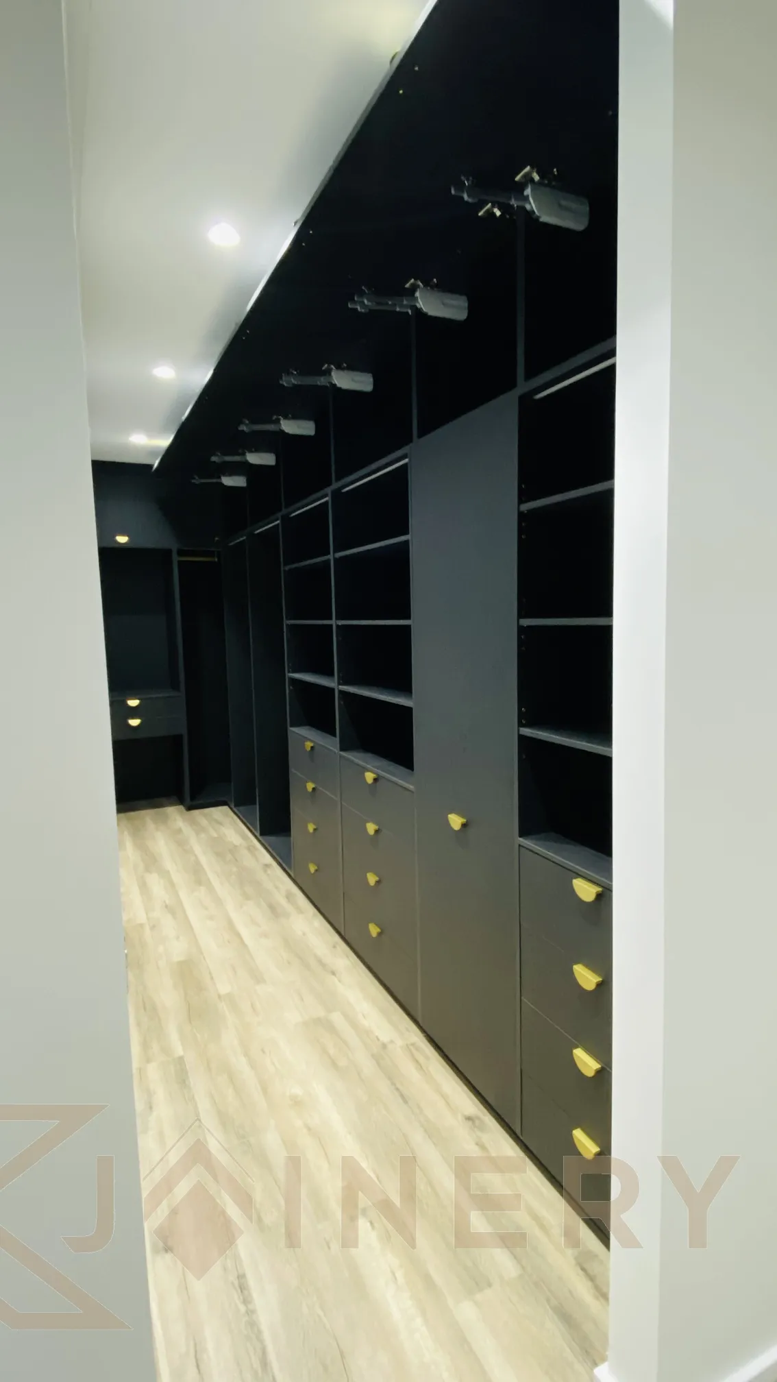 Dark custom wardrobe with brass handles and integrated lighting in Melbourne by KJoinery Australia