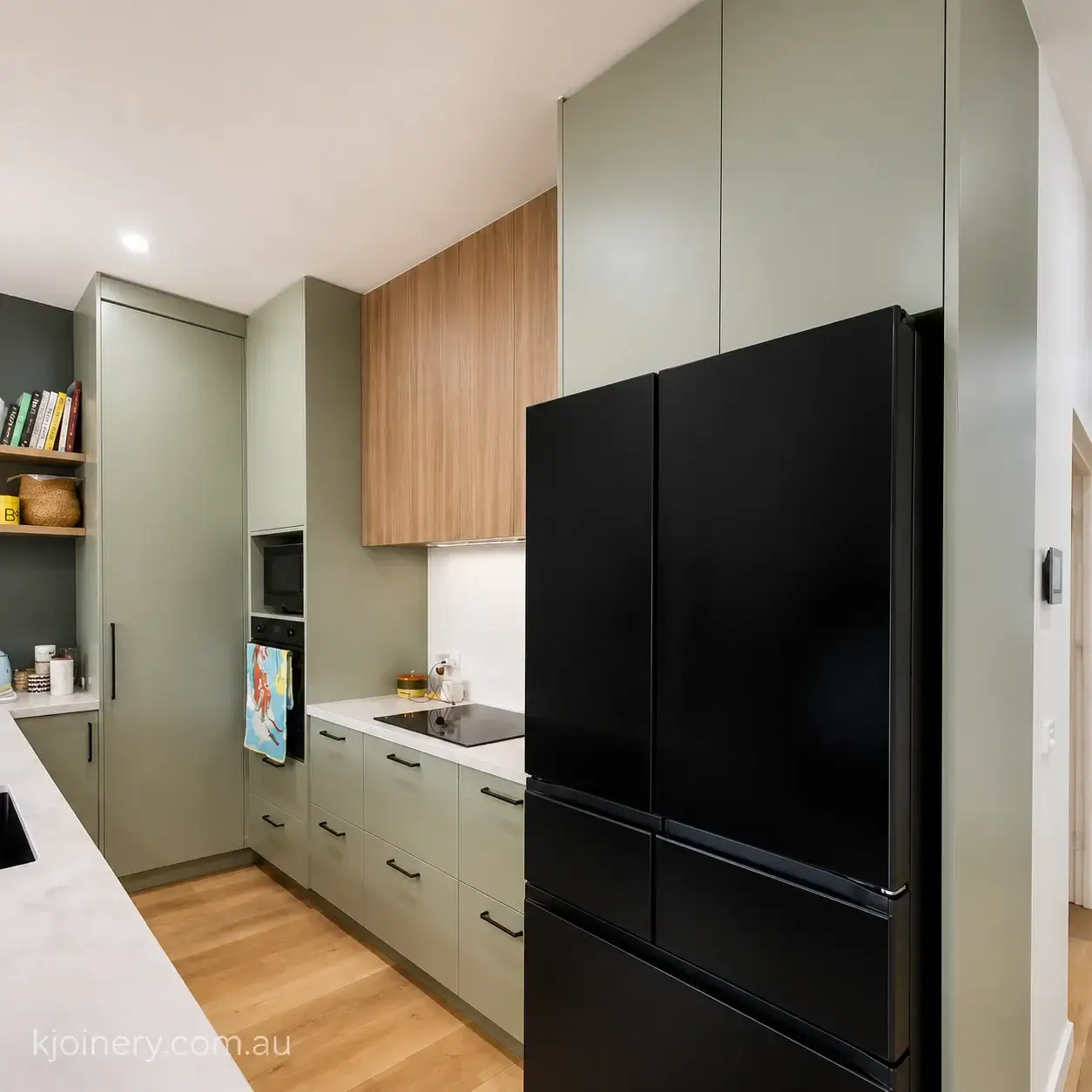 Custom kitchen joinery St Kilda — bespoke kitchen renovation with handleless cabinetry and stone benchtop by KJoinery Australia