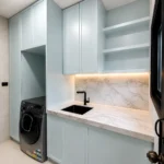 European laundry with 2-pac cabinetry, 30mm stone benchtop and black sink by KJoinery Melbourne