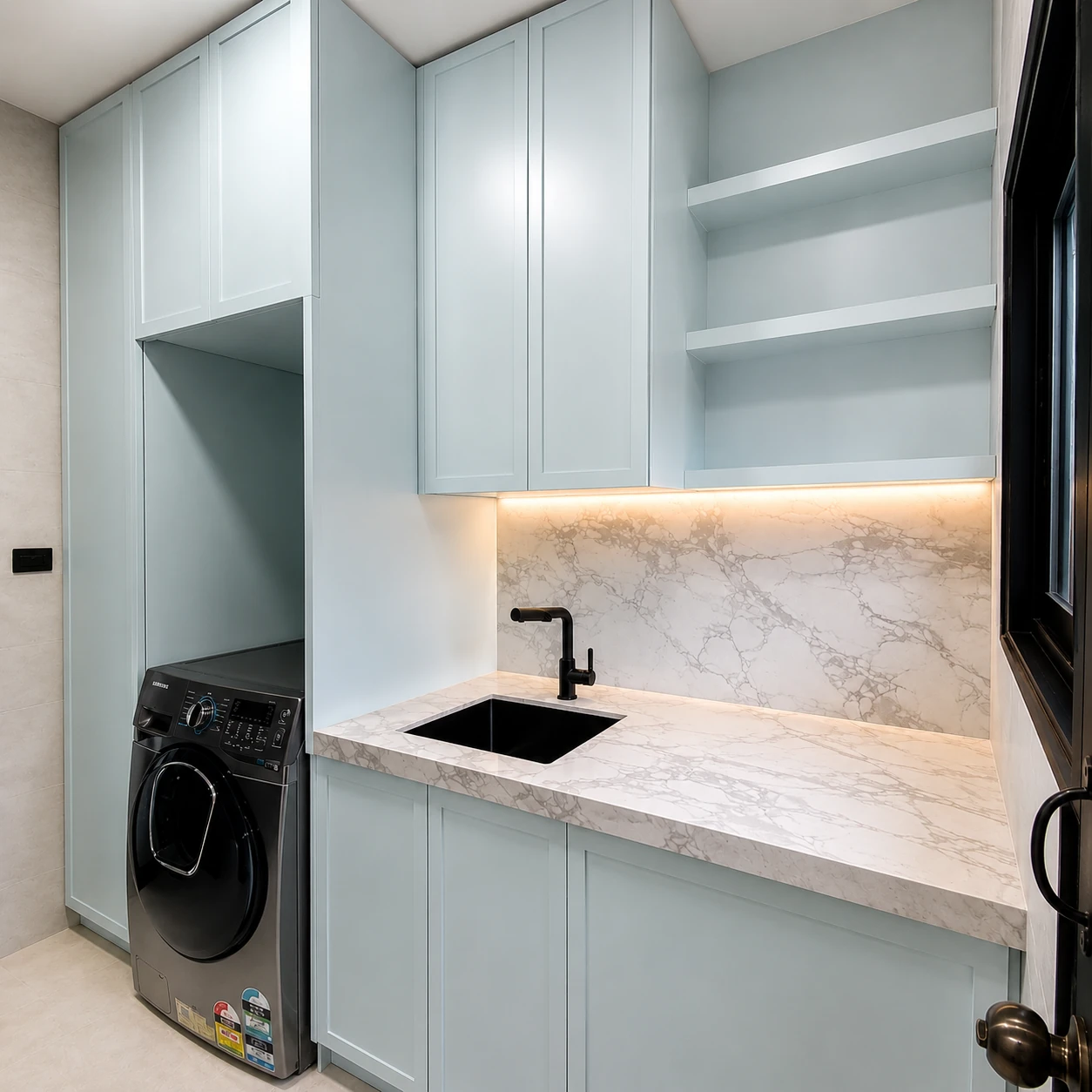Custom laundry joinery in Melbourne with sage cabinetry, stone benchtop and marble splashback