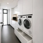 European laundry with side-by-side washer and dryer and full-height cabinetry in Melbourne