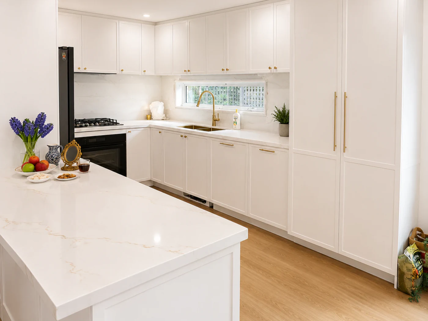 Finished shaker kitchen in Bulleen with stone benchtops and pantry towers
