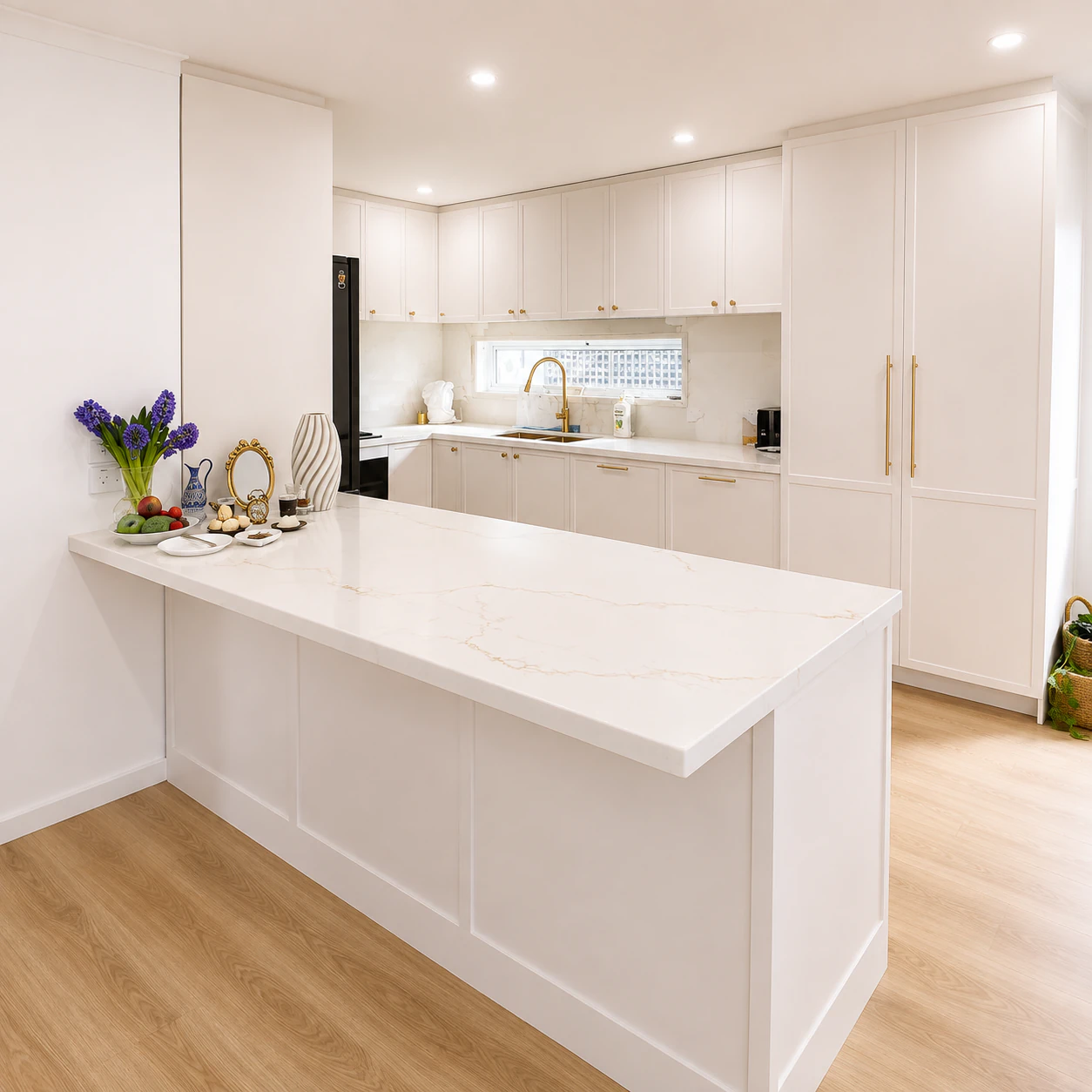 Open plan kitchen renovation in Bulleen with a stone peninsula and white shaker cabinetry