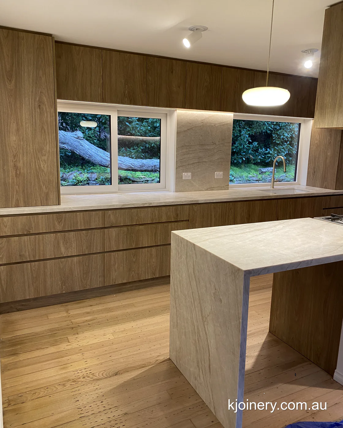 Santorini Gold stone peninsula with a mitred waterfall end in an Essendon kitchen