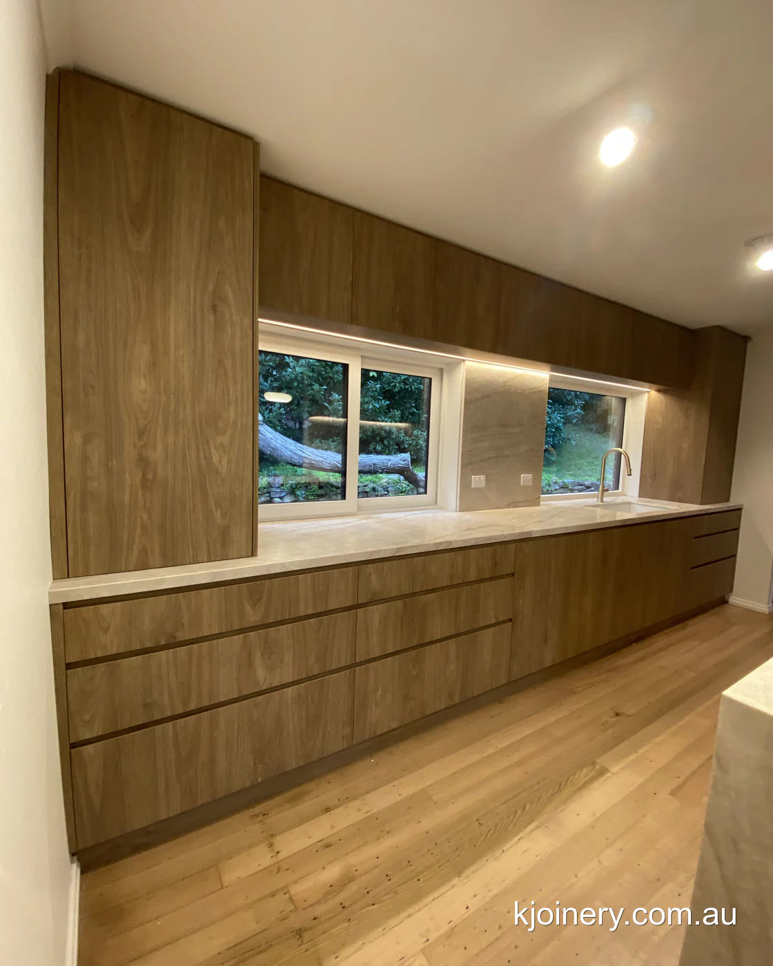 Deep Prime Oak drawer bank running the length of the window in an Essendon kitchen