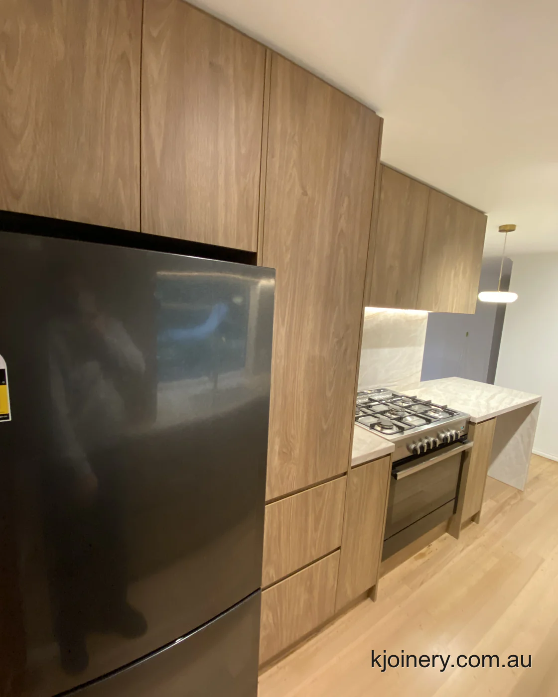 Full height Prime Oak tall cabinetry and integrated fridge in an Essendon kitchen