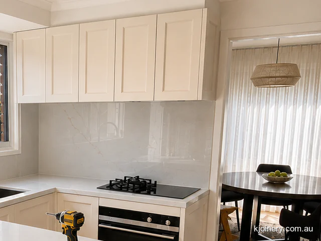 Gas cooktop against a full height stone splashback in a Caroline Springs kitchen renovation