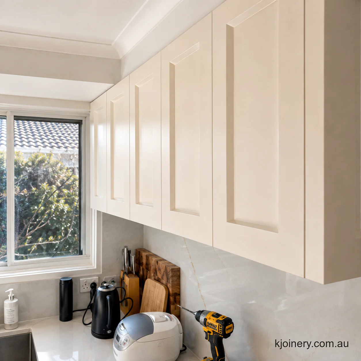 Full height stone splashback and shaker overhead cabinets in a Caroline Springs kitchen
