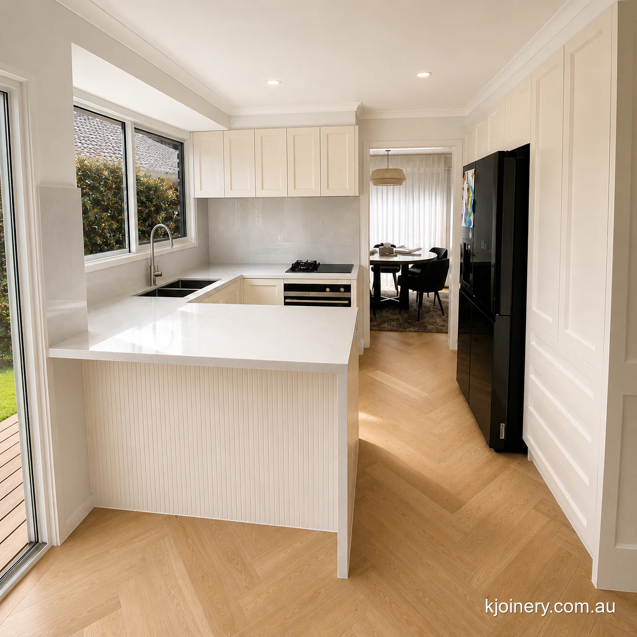 U-shaped kitchen in Caroline Springs with stone peninsula looking through to the dining room