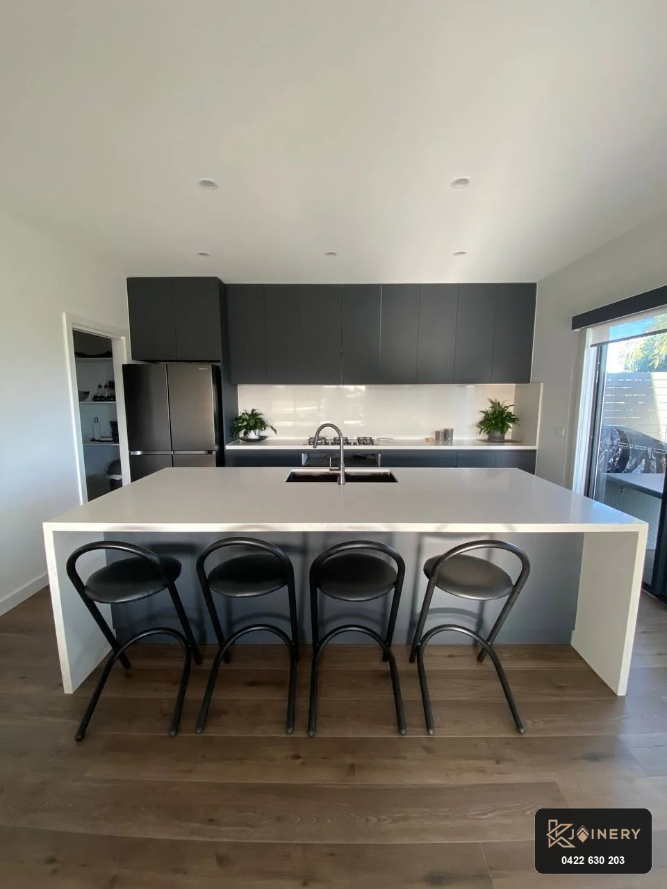 Symmetrical view of Altona kitchen island in Laminex AbsoluteMatte with undermount sink, gooseneck tap and 4 bar stools