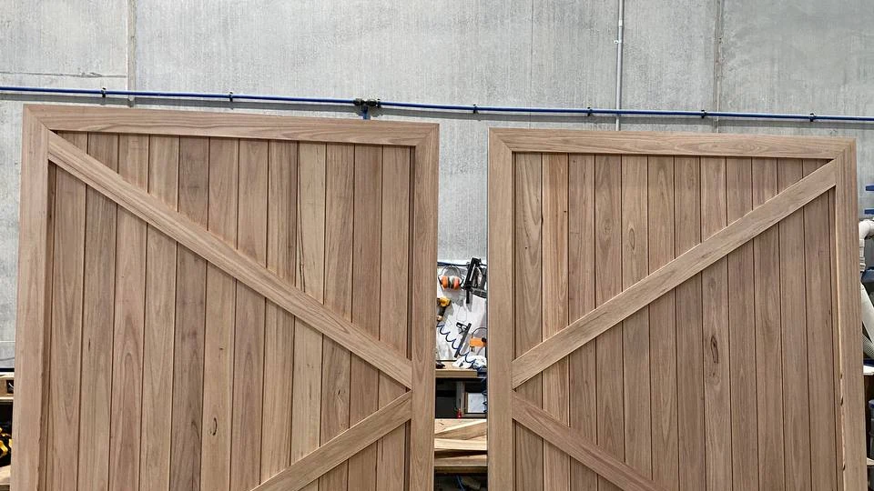 Pair of custom solid timber sliding barn doors with mirrored chevron bracing crafted by KJoinery Melbourne