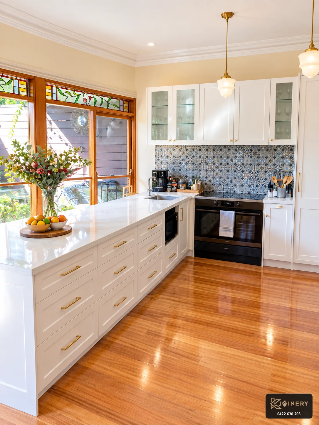 Custom kitchen island bench in West Footscray featuring undermount sink and stone waterfall edge