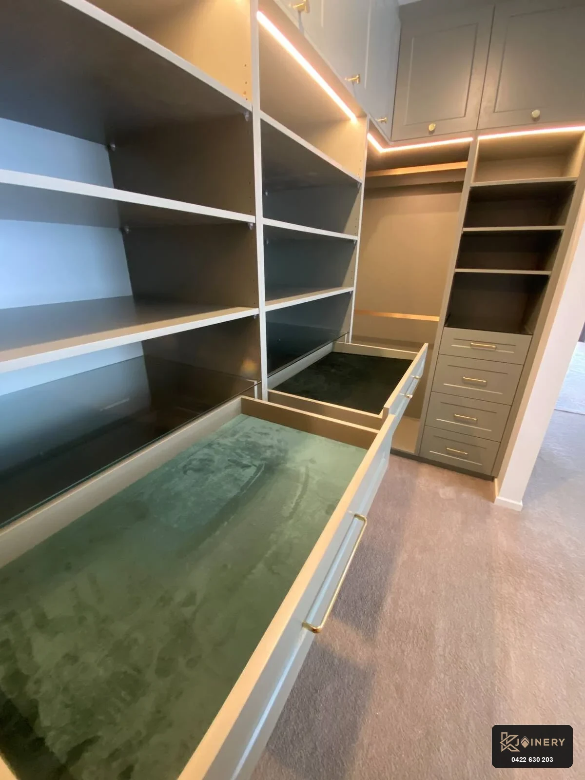 Glass-top jewelry drawers in custom walk in wardrobe Point Cook showing emerald velvet display compartments